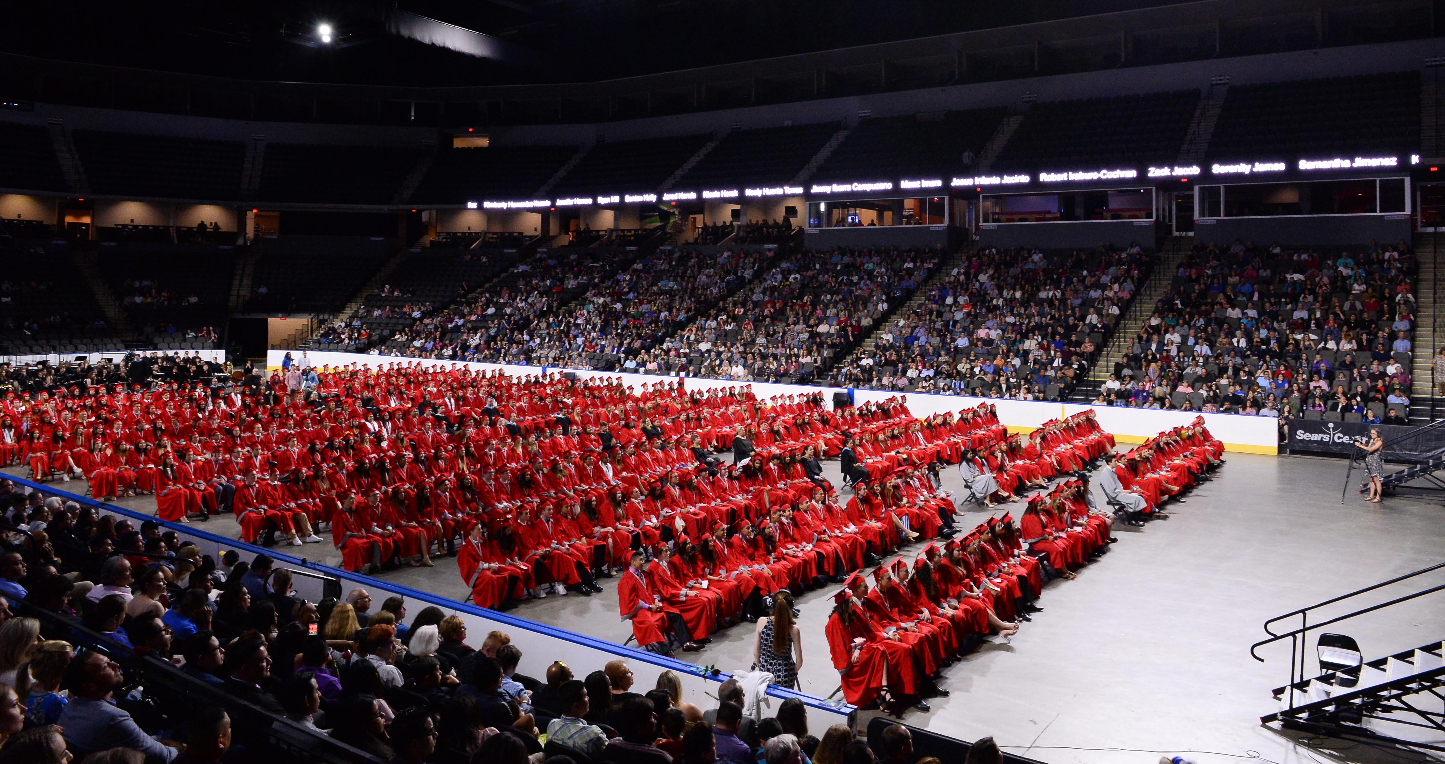 Class of 2018 in red caps and gowns at Graduation