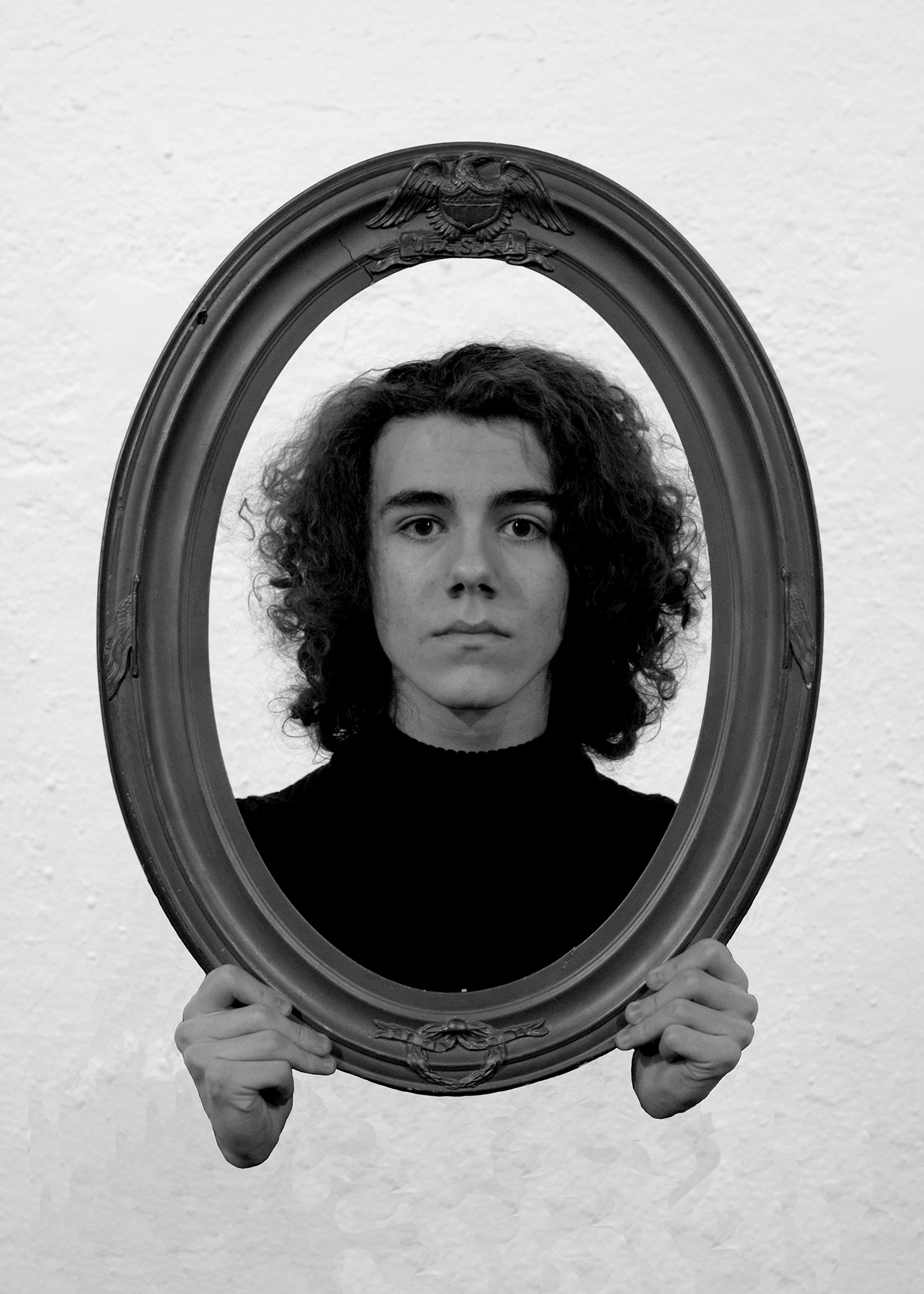 Matthew Callas as Elephant Man looking into a mirror with blank expression