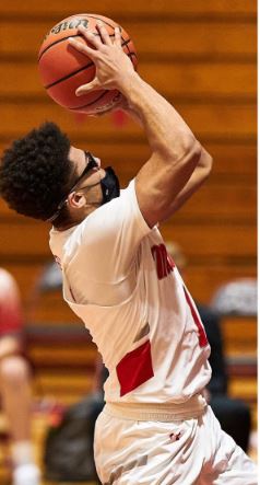 Action shot of Trey Baker shooting a basket