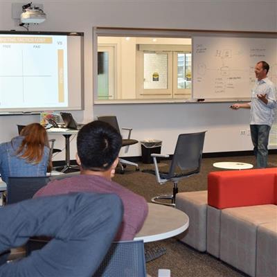 teacher using smart board in business incubator classroom